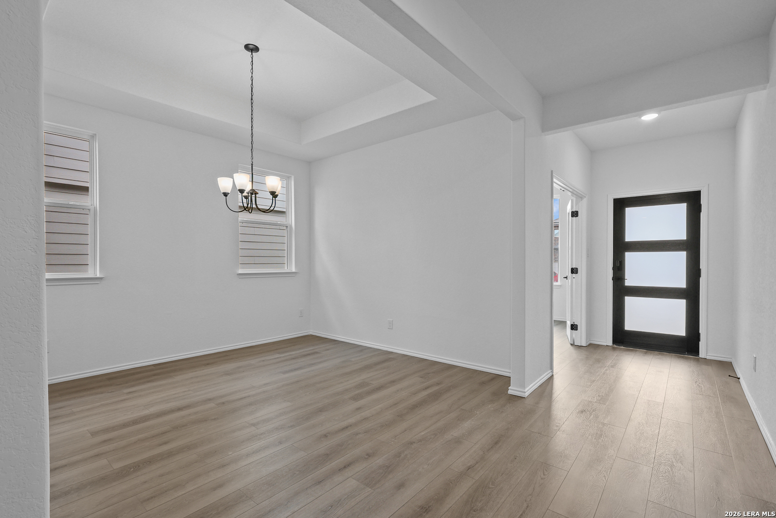 7432 Cremorne Converse, TX 78109 - Photo 8 of 35 a view of empty room with wooden floor chandelier and window