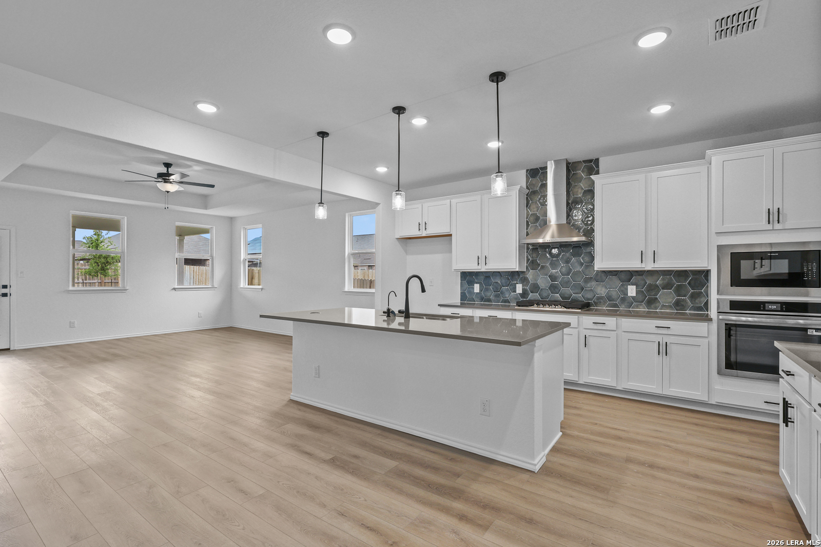 7432 Cremorne Converse, TX 78109 - Photo 10 of 35 a kitchen with stainless steel appliances granite countertop a sink cabinets and wooden floor