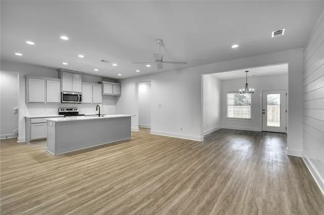 a view of kitchen with granite countertop cabinets and wooden floor