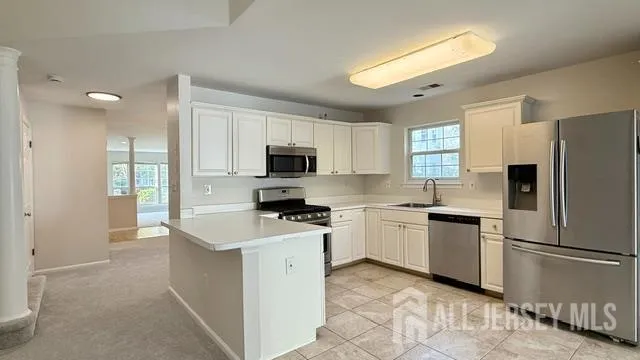 a kitchen with a refrigerator stove microwave and sink