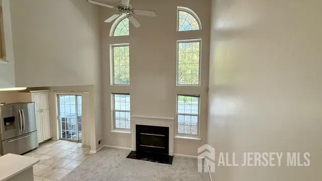 a living room with furniture and two windows