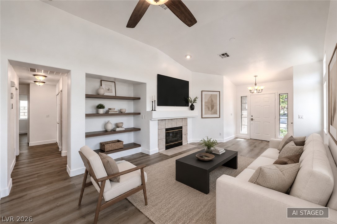 1900 Cardinal Point Street Henderson, NV 89012 - Photo 9 of 32 A welcoming living area boasts an inviting fireplace and integrated shelving, perfect for showcasing treasured items.