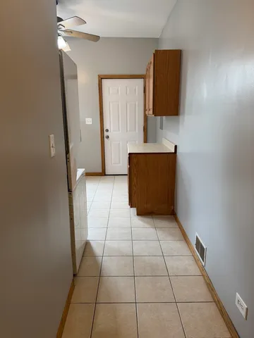 a kitchen with a stove sink and cabinets