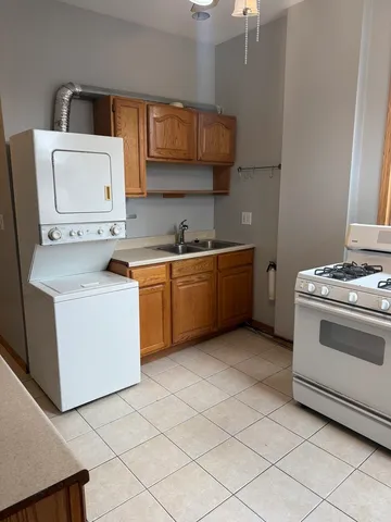 a kitchen with stainless steel appliances granite countertop a stove and a refrigerator