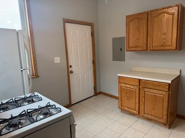 a kitchen with a stove sink and cabinets