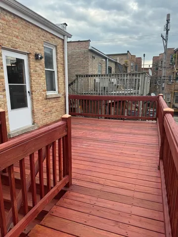 a view of balcony with wooden floor