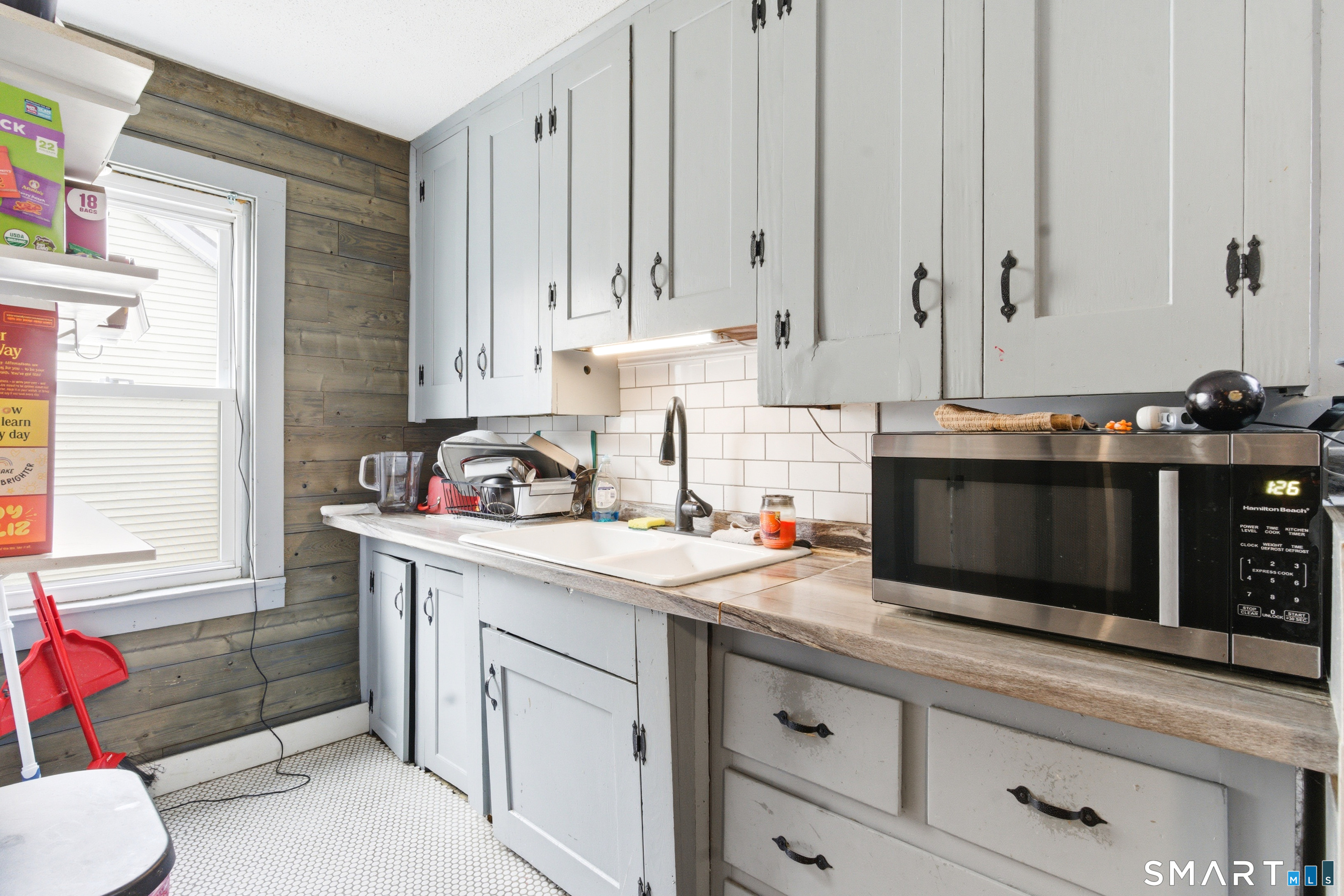36 Church Street Killingly, CT 06241 - Photo 25 of 39 a kitchen with stainless steel appliances a stove a sink and white cabinets