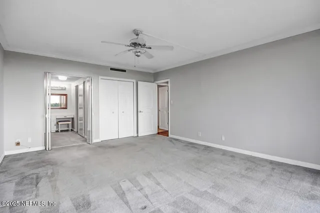 a living room with furniture and a dining table with kitchen view