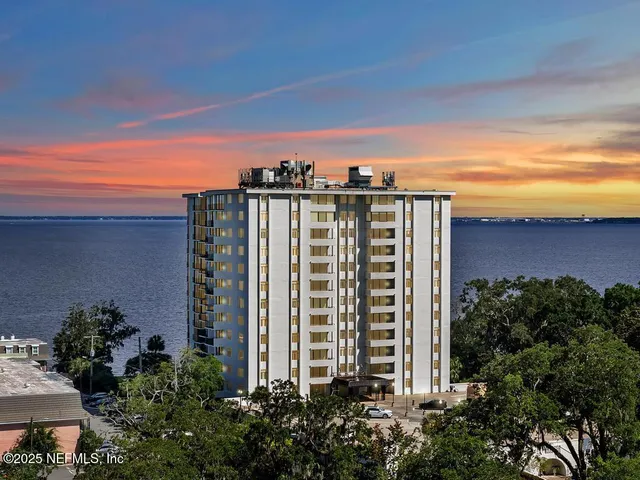 a view of an empty room with window and cabinet