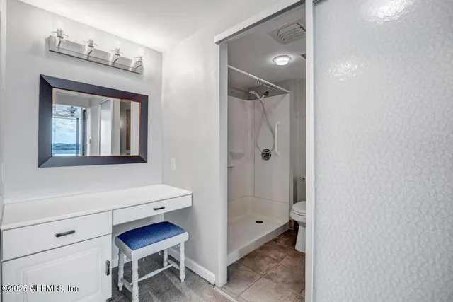 a spacious bathroom with a granite countertop sink and a mirror