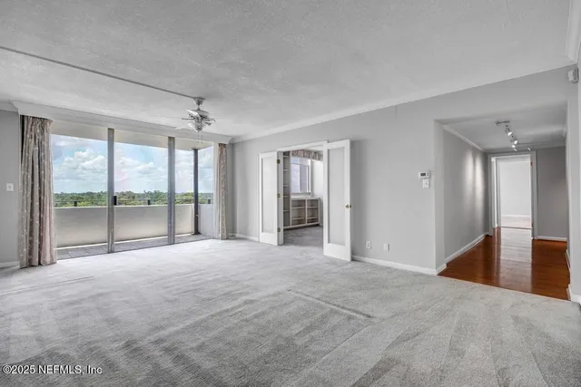 a view of a livingroom with a chandelier fan