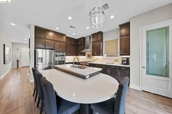 a large kitchen with a table and chairs