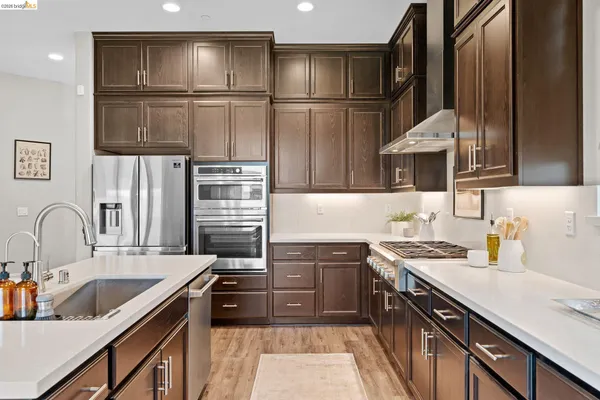 a large kitchen with a table and chairs