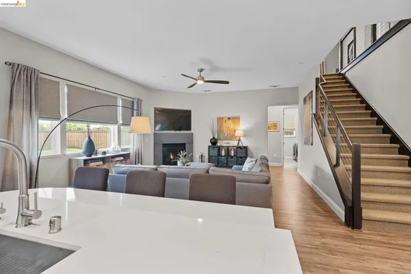 a living room with fireplace furniture and a large window