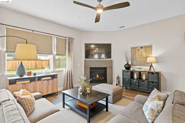 a living room with furniture a fireplace and a flat screen tv