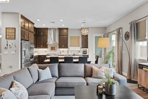a living room with furniture and a kitchen view
