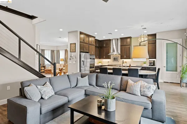 a living room with furniture and a view of kitchen