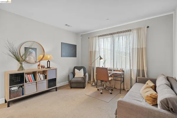a view of a livingroom with furniture and a bookshelf