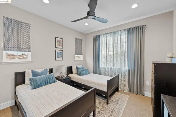 a bedroom with a bed and a painting on the wall