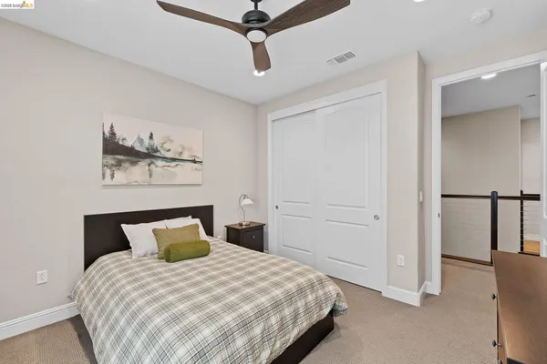 a spacious bedroom with a bed and a window
