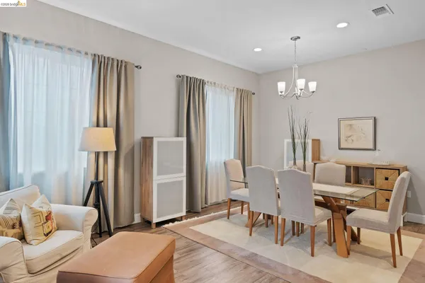 a view of a dining room with furniture and a chandelier