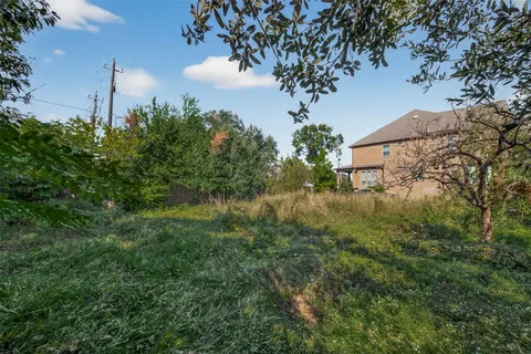 an aerial view of a residential houses with street