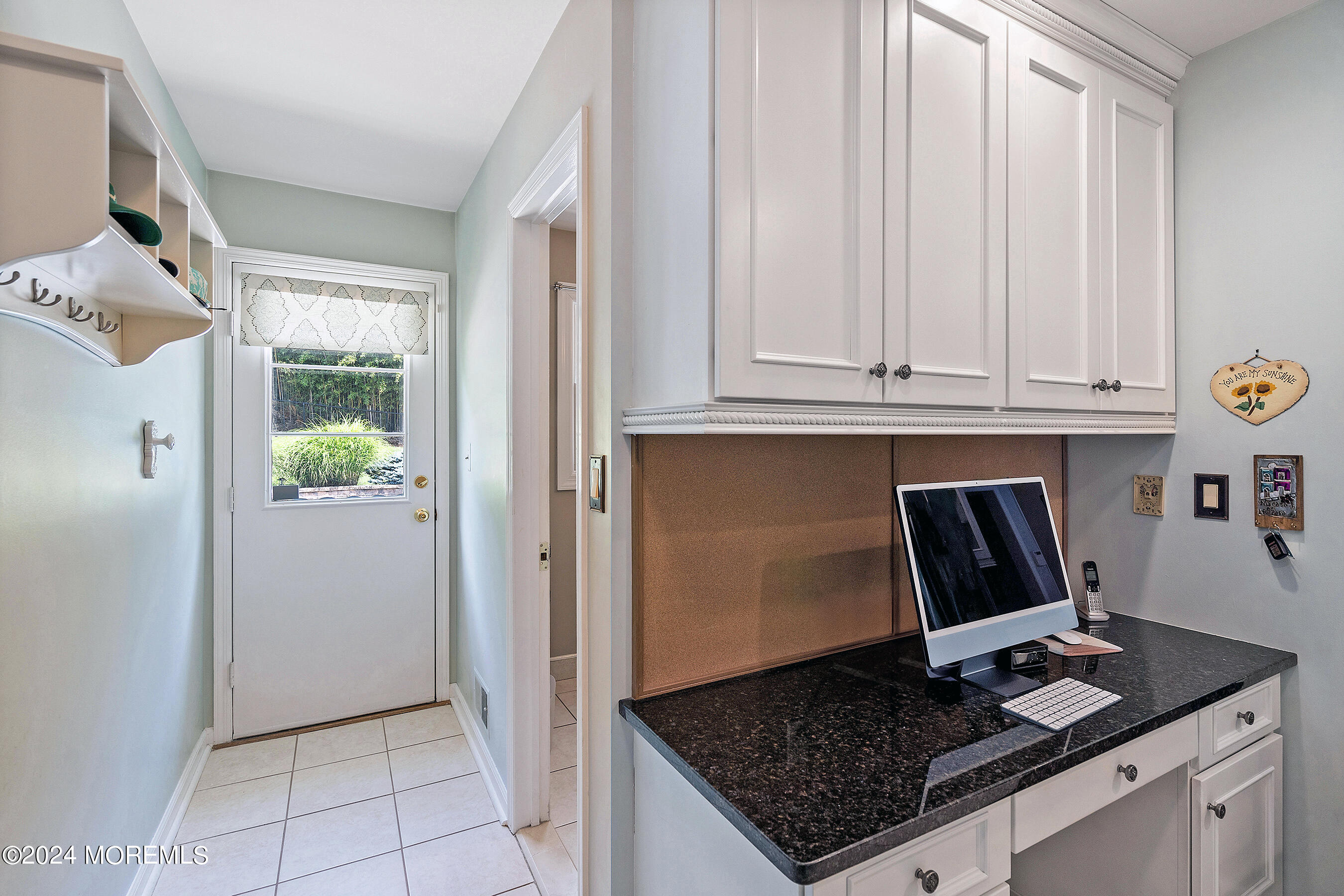 9 Doherty Drive Middletown, NJ 07748 - Photo 19 of 59 a kitchen with granite countertop a sink and white cabinets
