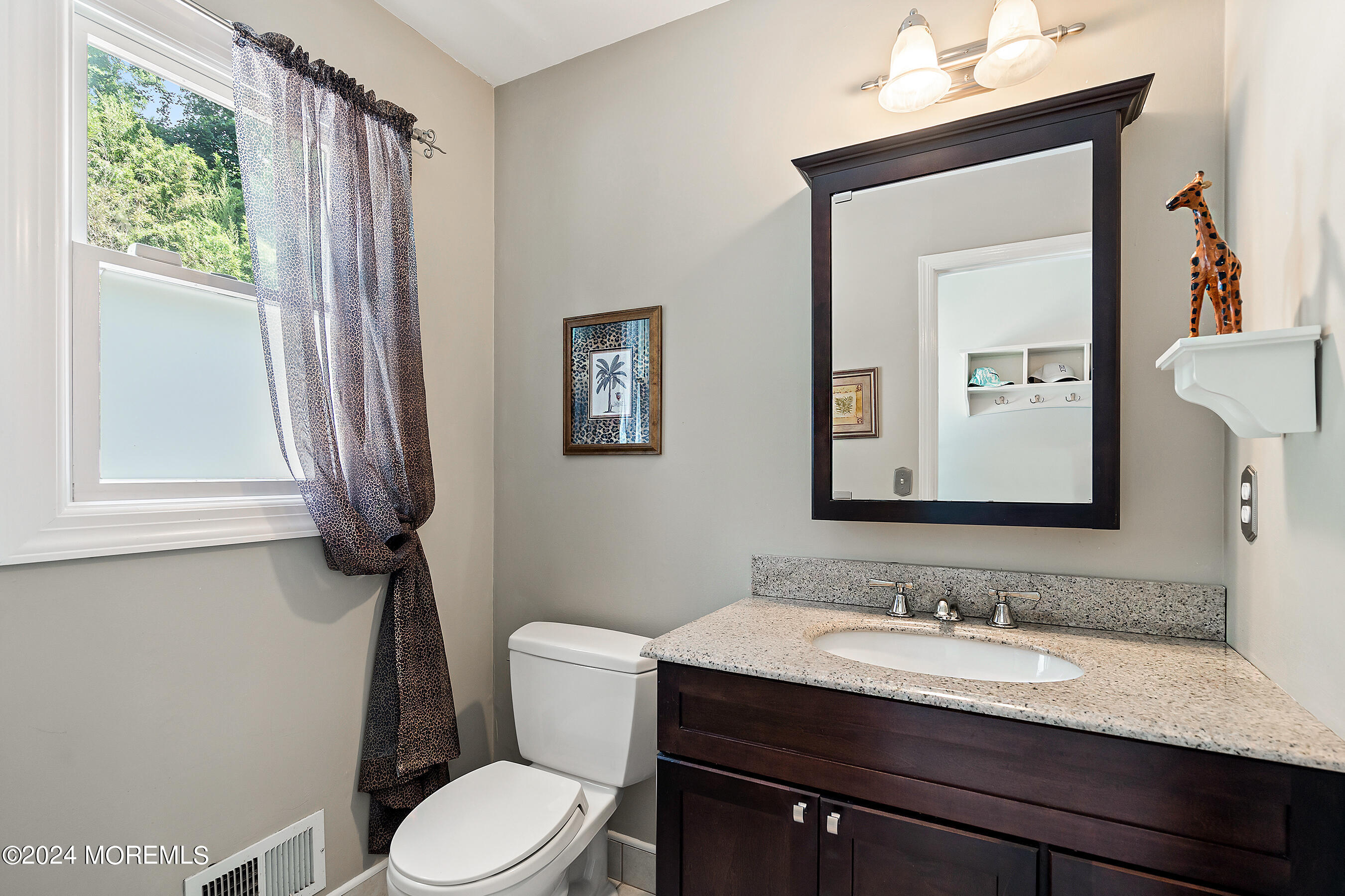 9 Doherty Drive Middletown, NJ 07748 - Photo 21 of 59 a bathroom with a granite countertop sink toilet a mirror and a window