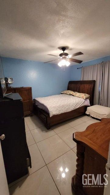 Undisclosed Address Bakersfield, CA 93309 - Photo 6 of 8 a bedroom with two beds and a lamp with the dresser