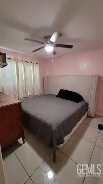 Undisclosed Address Bakersfield, CA 93309 - Photo 7 of 8 a bedroom with a bed and a chandelier