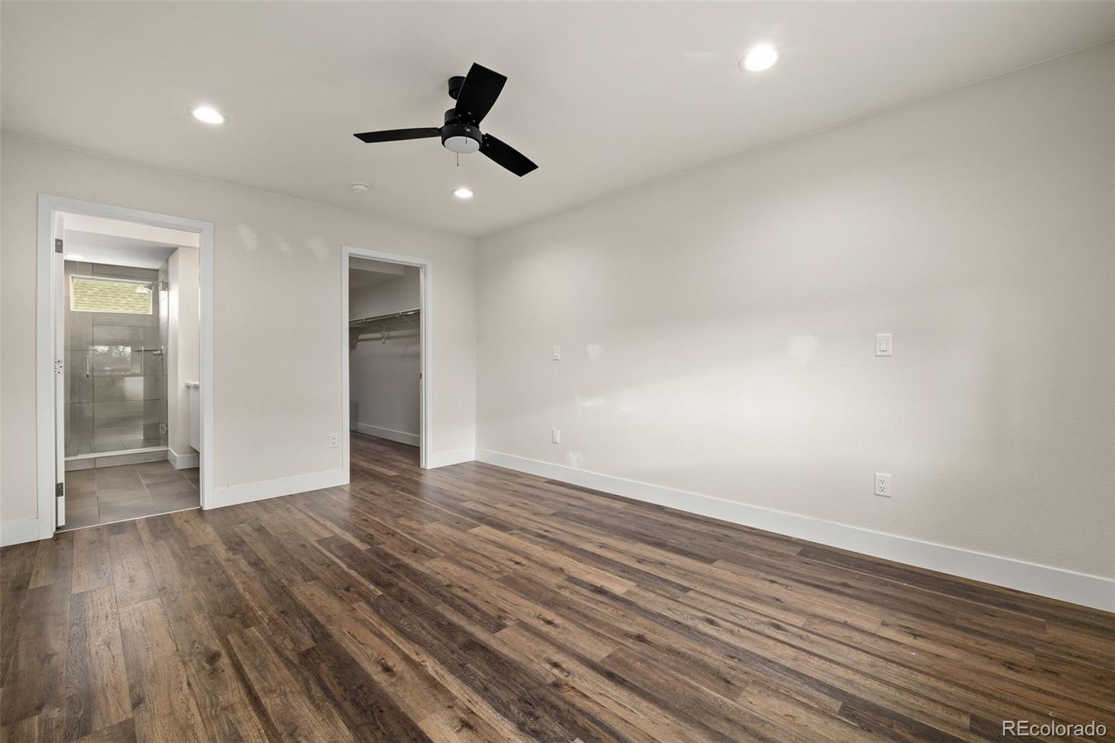 1204 South Reed Street Lakewood, CO 80232 - Photo 31 of 45 a view of empty room with wooden floor