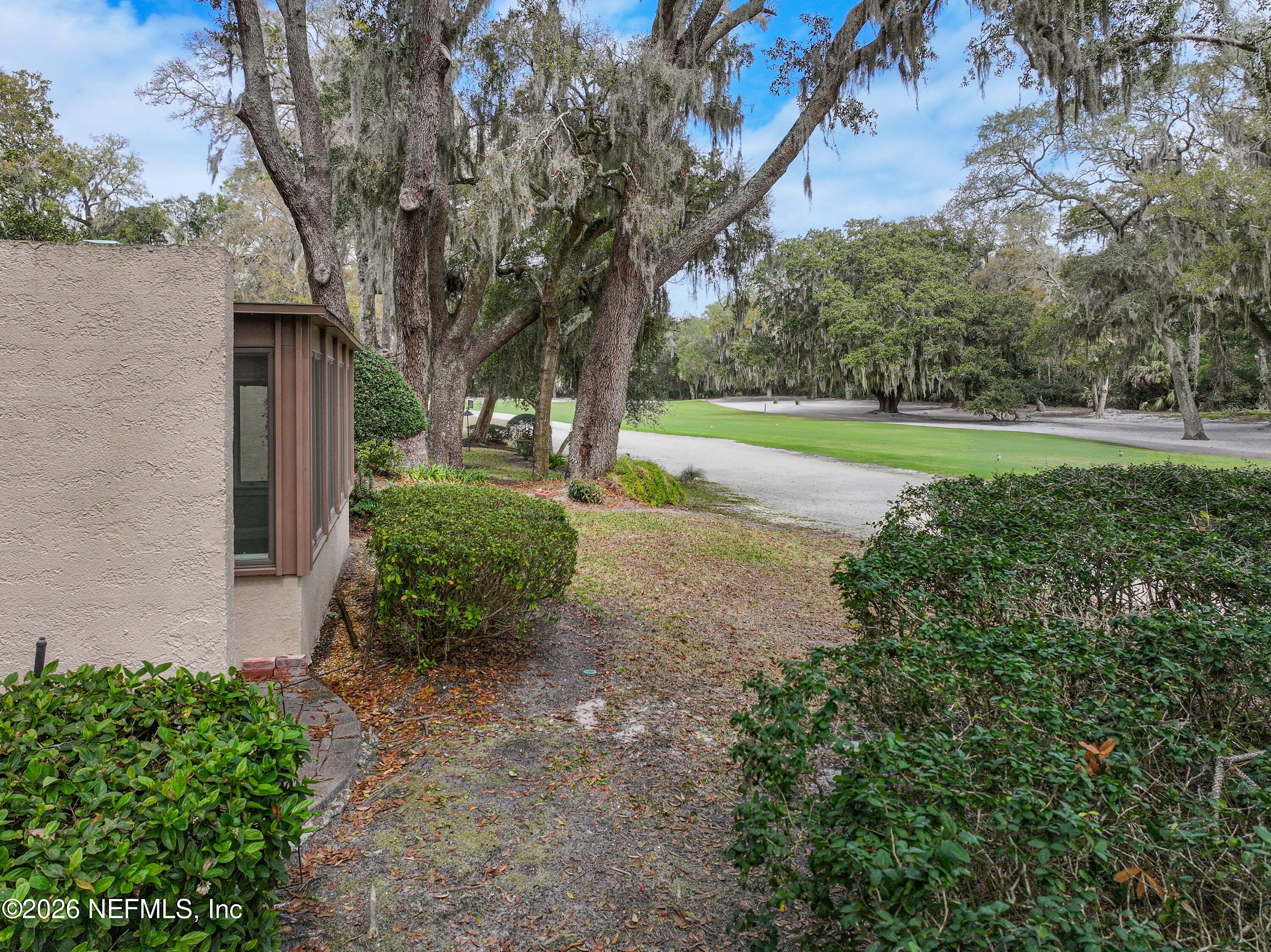 3301 Sea Marsh Road Fernandina Beach, FL 32034 - Photo 33 of 41 a view of a garden with large trees