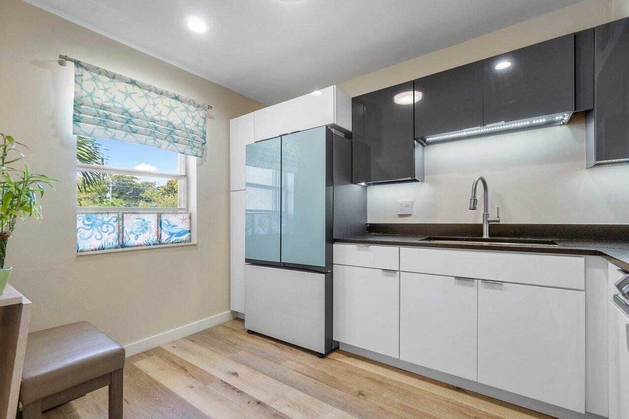 a kitchen with stainless steel appliances a refrigerator and a sink