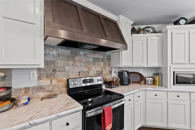 a kitchen with stainless steel appliances granite countertop a stove a sink and cabinets