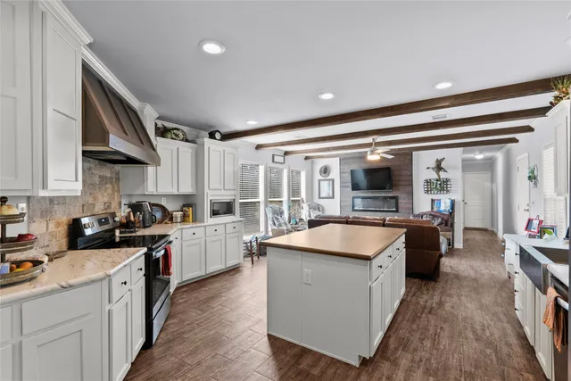 a kitchen with stainless steel appliances granite countertop a stove and a sink
