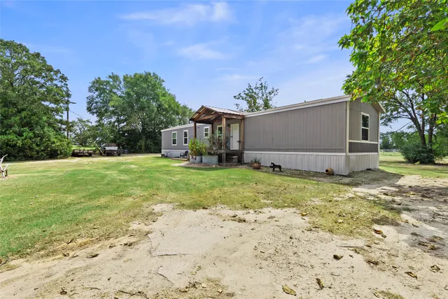 a backyard of a house with lots of green space