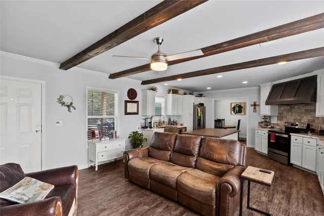 a view of a living room kitchen and a wooden floor