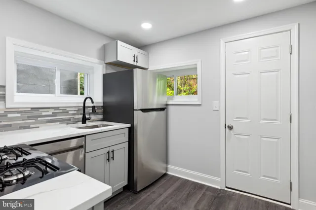 a kitchen with a sink appliances and cabinets