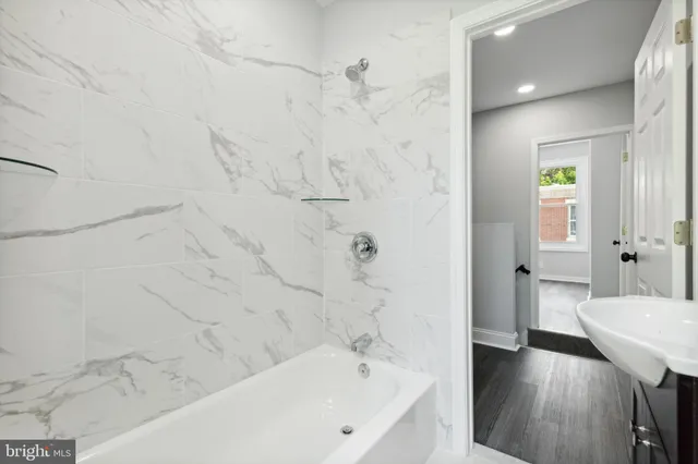 a bathroom with a bathtub and a shower