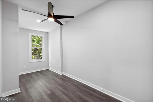 a view of room with window and wooden floor