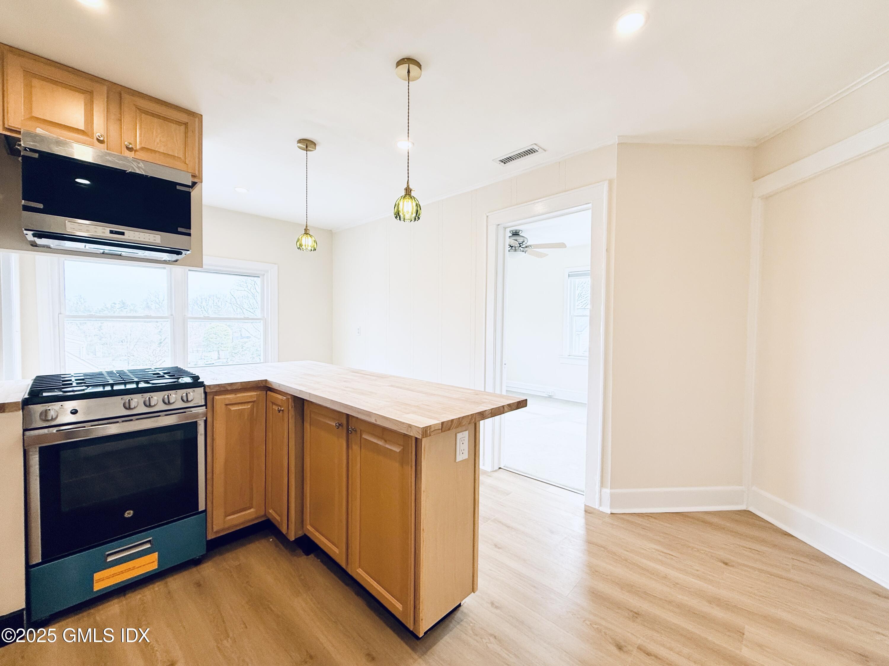 237 Hamilton Avenue, Unit 2 Greenwich, CT 06830 - Photo 4 of 20 a kitchen with stainless steel appliances granite countertop a stove a sink and a refrigerator