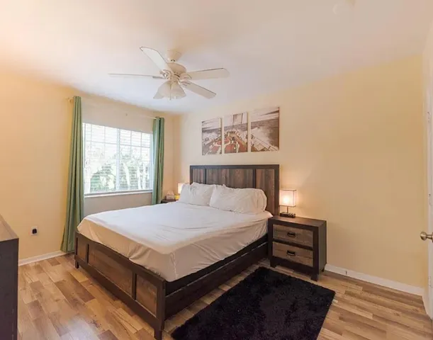 a bed sitting in a bedroom next to a window