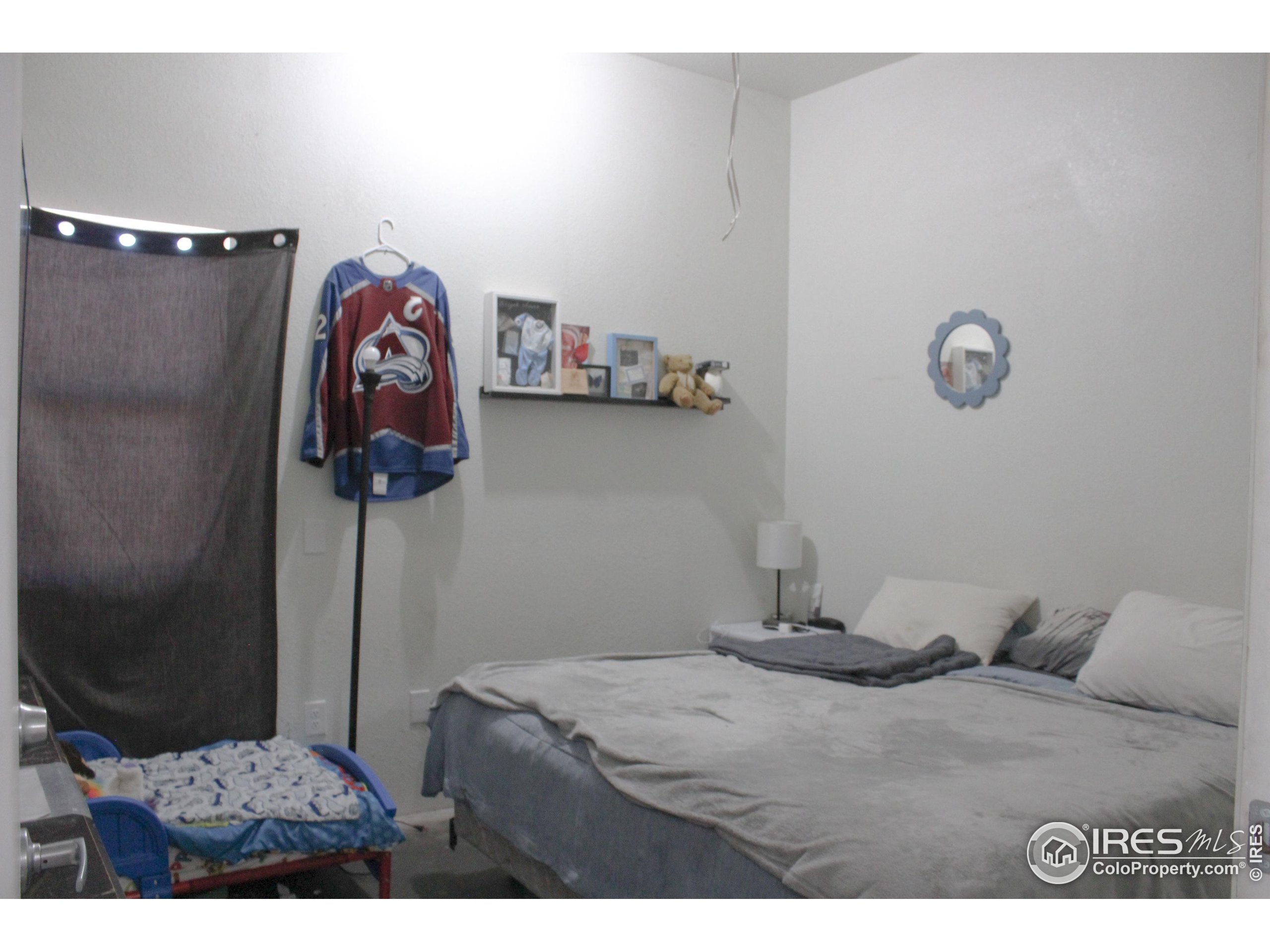 504 12th Street Greeley, CO 80631 - Photo 11 of 19 a bedroom with a bed and a table in it