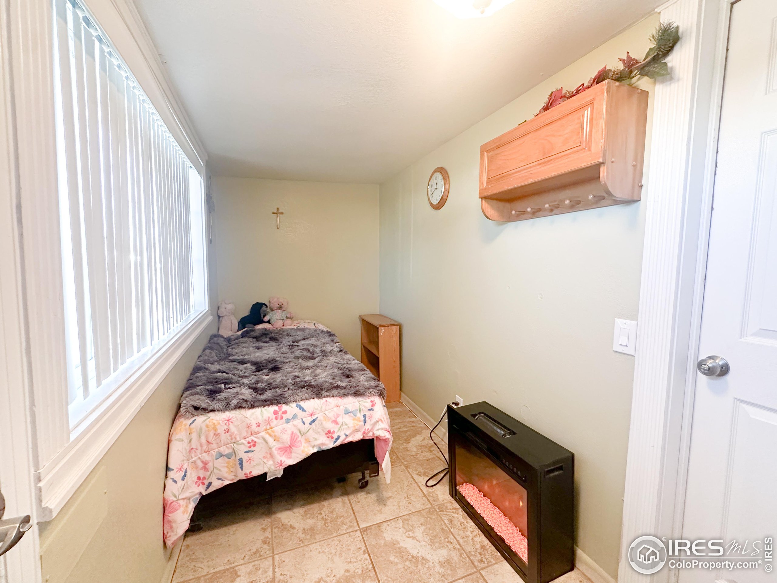 504 12th Street Greeley, CO 80631 - Photo 12 of 19 a bedroom with a bed and a window