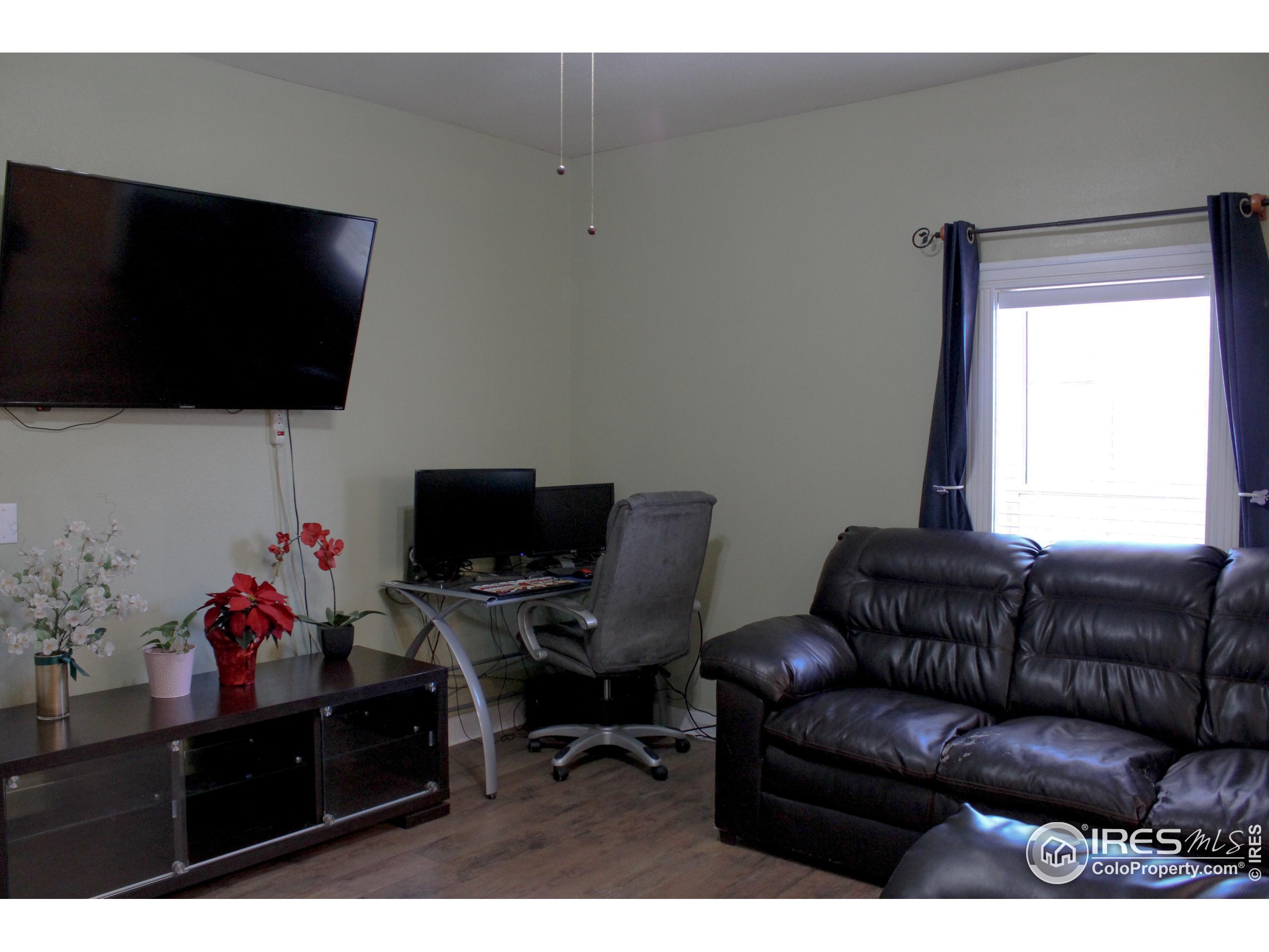504 12th Street Greeley, CO 80631 - Photo 8 of 19 a living room with furniture and a flat screen tv