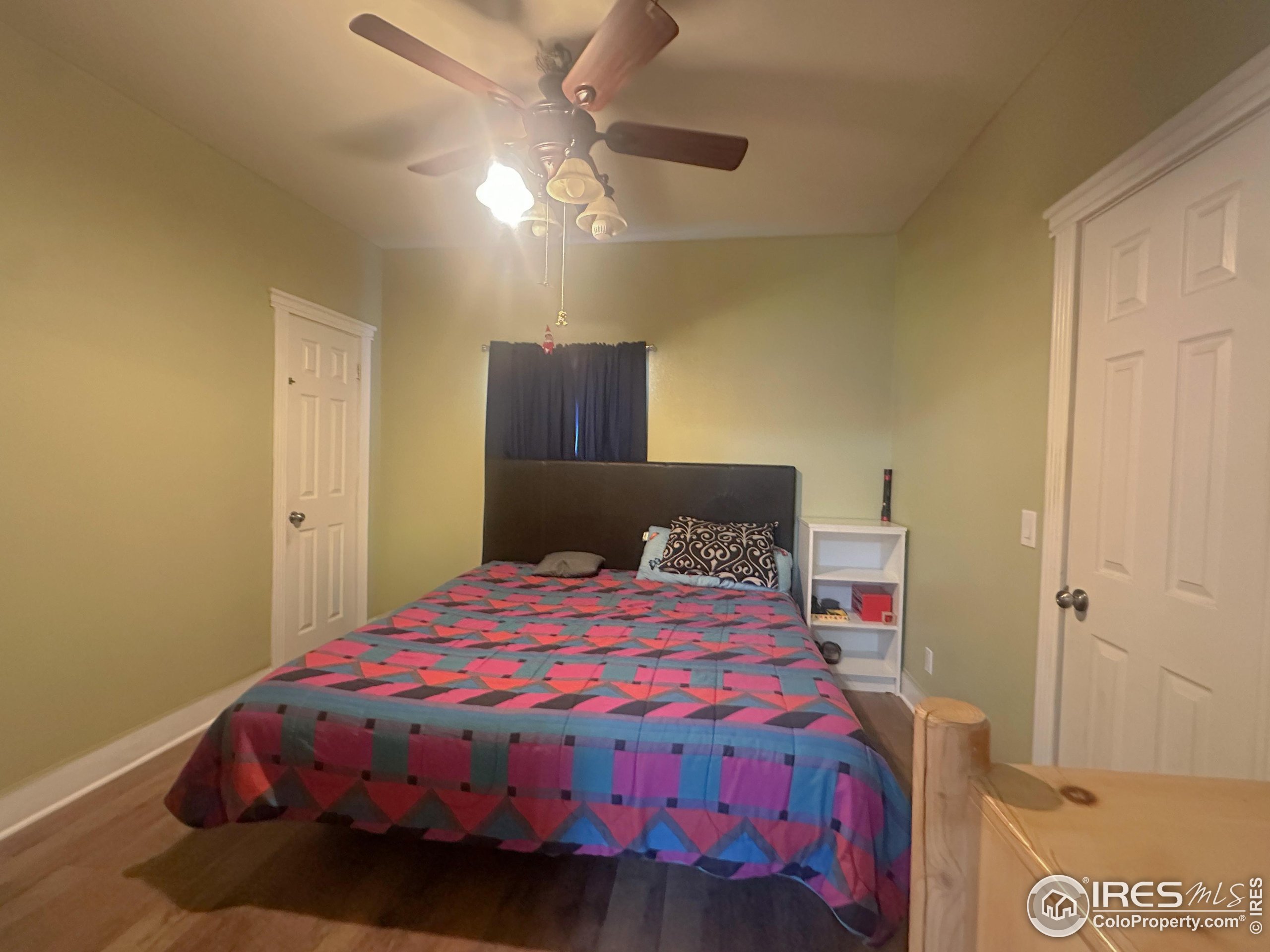 504 12th Street Greeley, CO 80631 - Photo 10 of 19 a bedroom with a bed and a chandelier