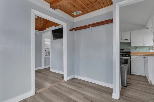 a view of a kitchen with wooden floor and a sink