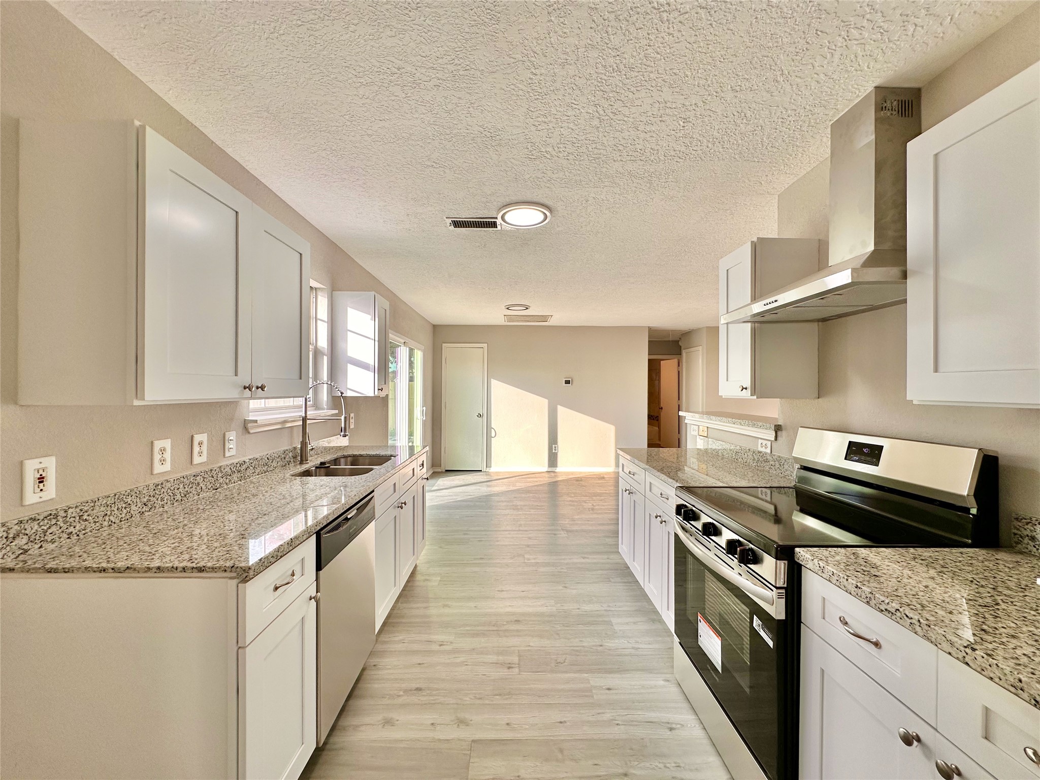 15134 Alkay Street Houston, TX 77053 - Photo 11 of 25 a kitchen with stainless steel appliances granite countertop a sink stove and cabinets