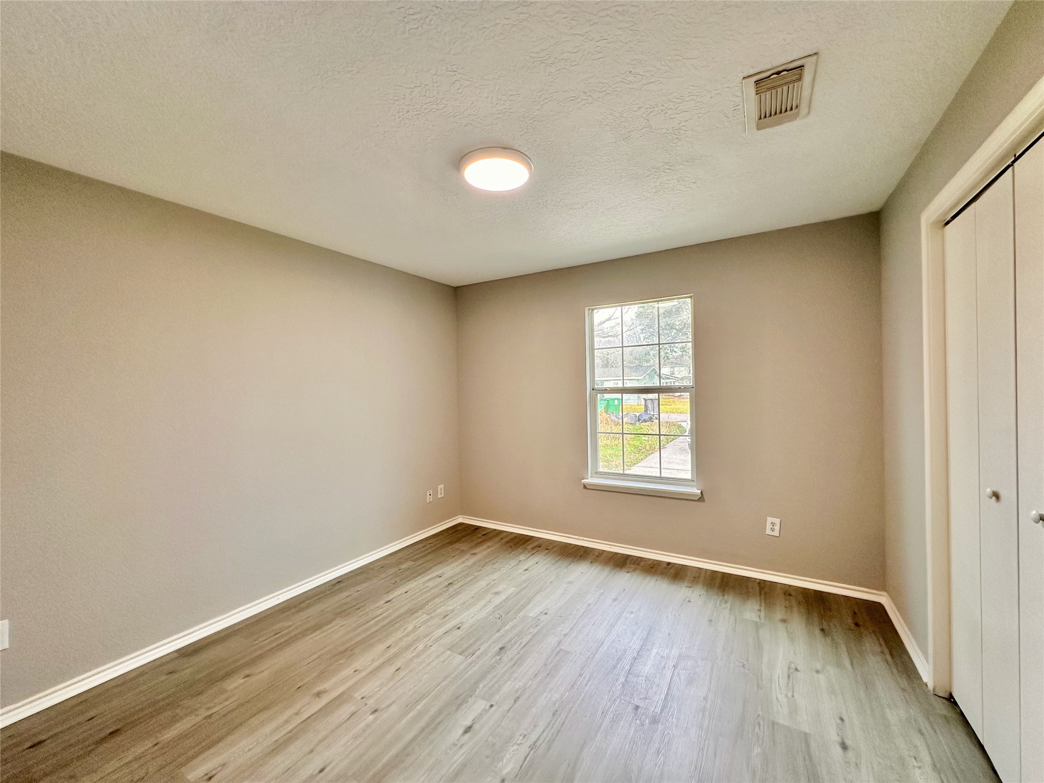 15134 Alkay Street Houston, TX 77053 - Photo 15 of 25 wooden floor in an empty room with a window