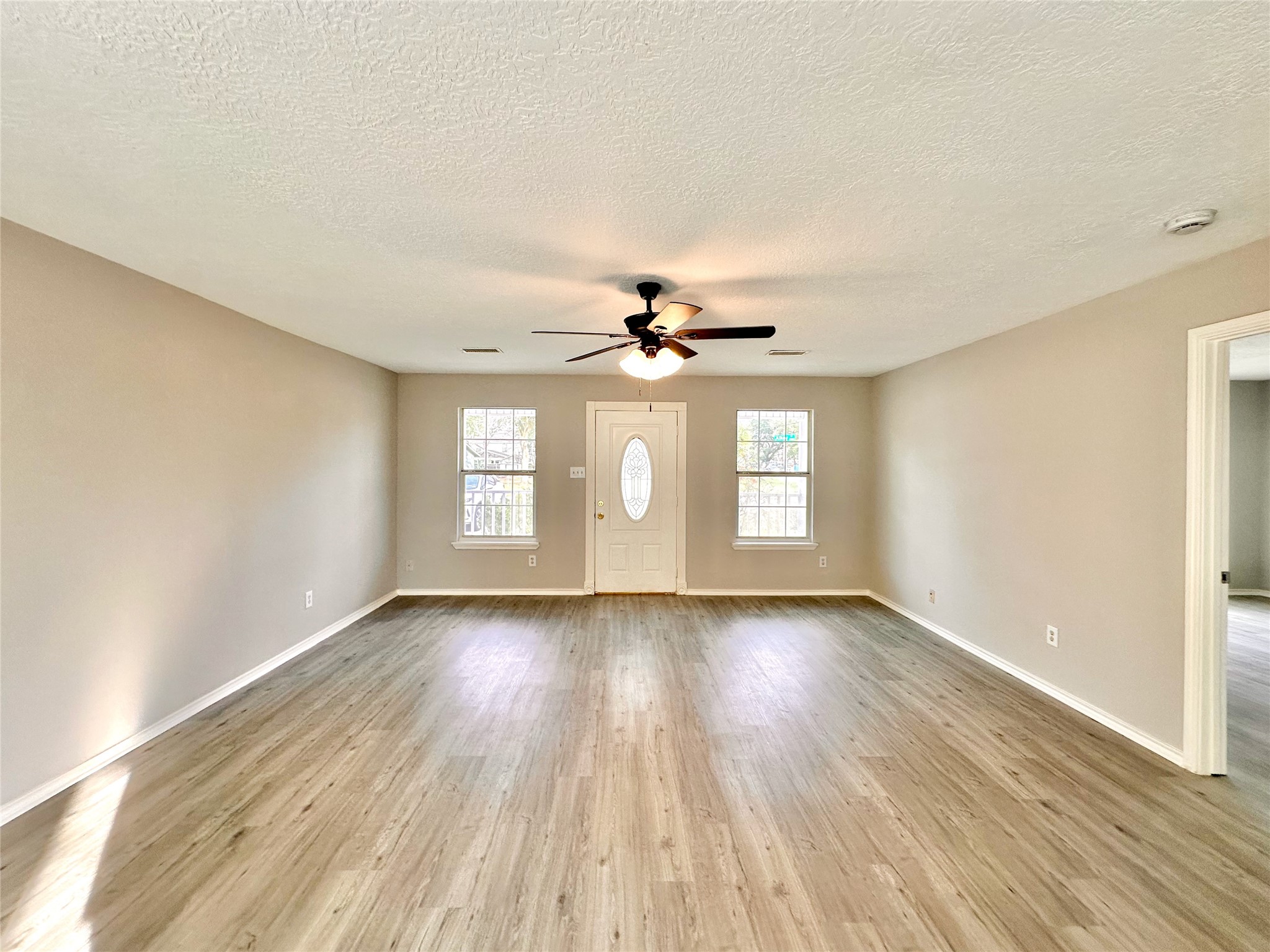 15134 Alkay Street Houston, TX 77053 - Photo 4 of 25 wooden floor in an empty room with a window